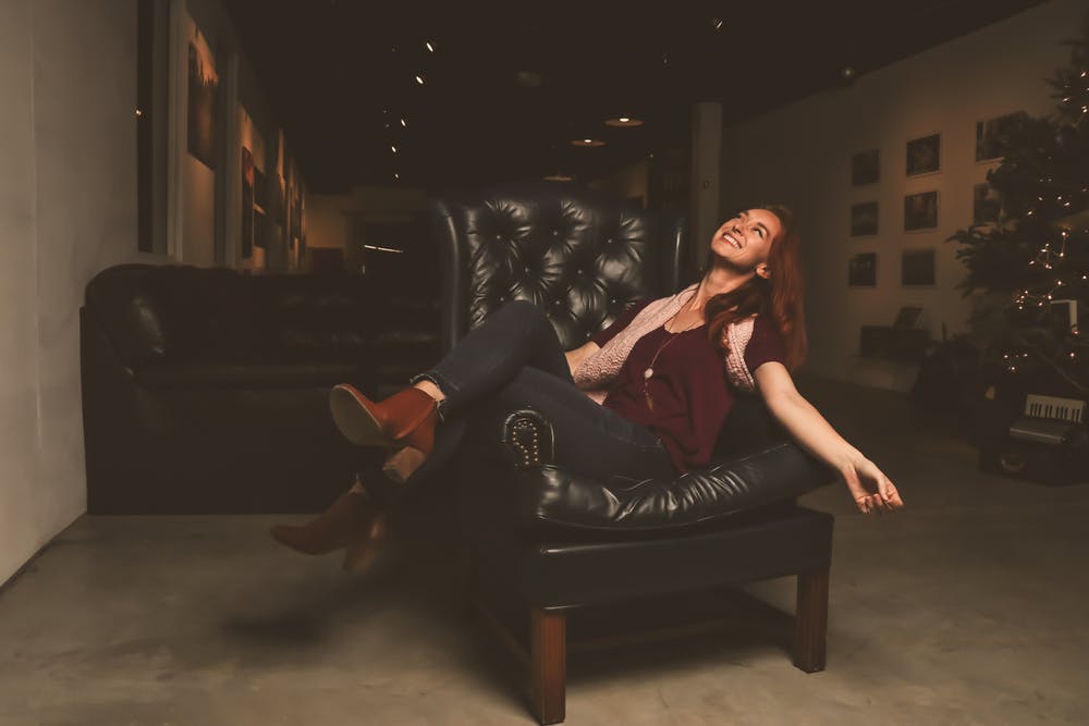 woman sitting in a leather lounge
