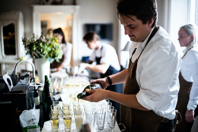 Waiter serving alcohol in a corporate event